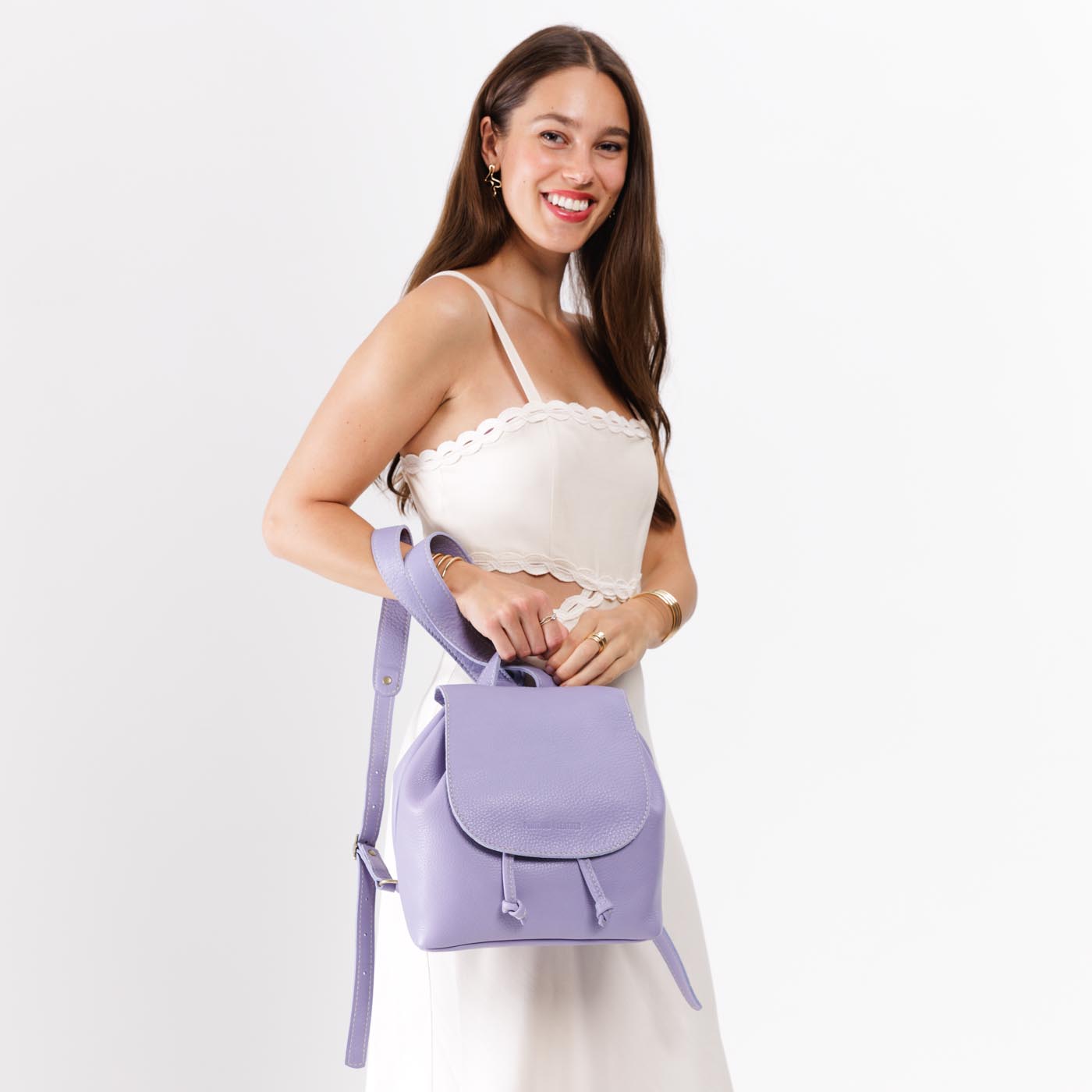 Wisteria | Model holding slouchy leather bucket backpack