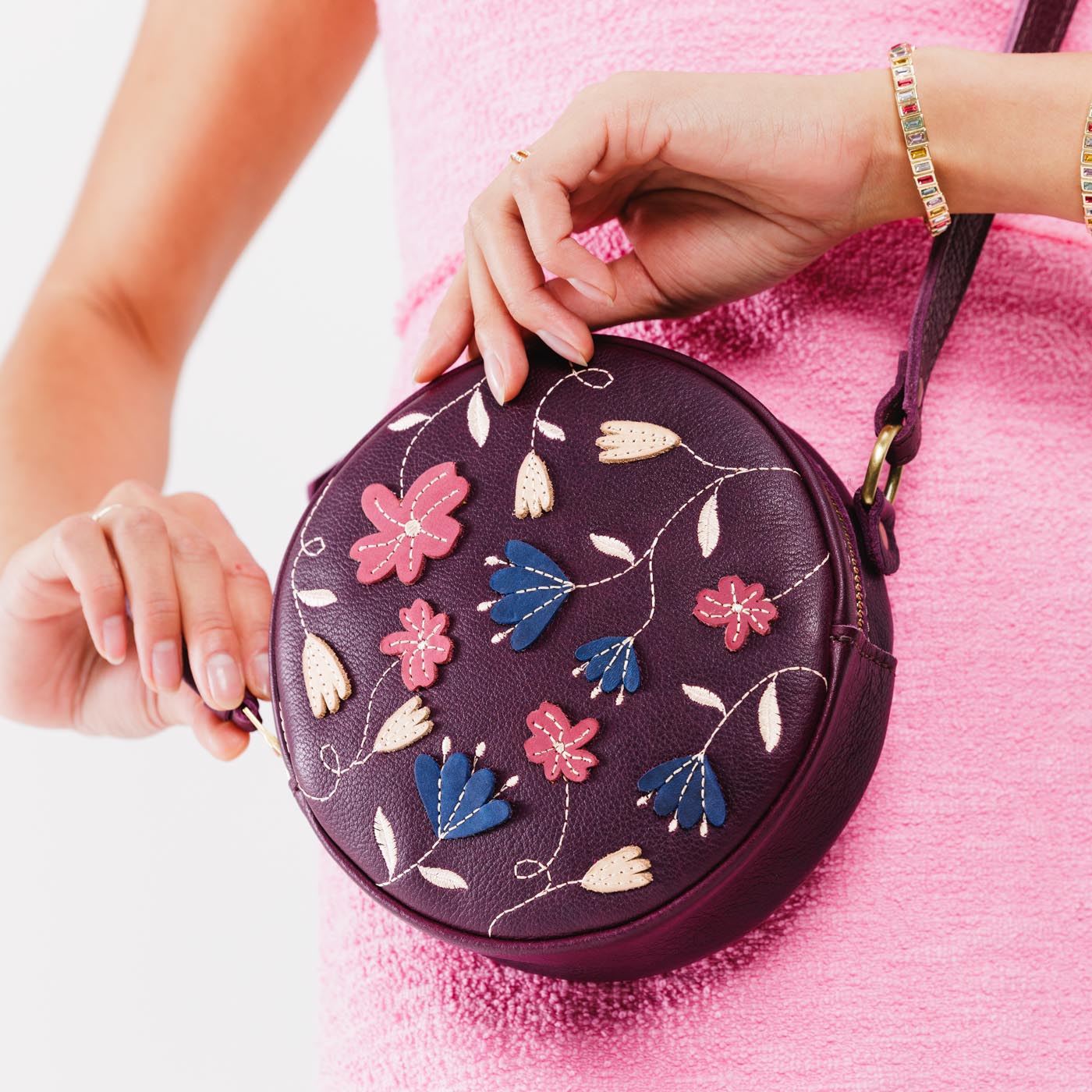 Folklore Plum Small | Circle shaped crossbody bag with embroidered flower design