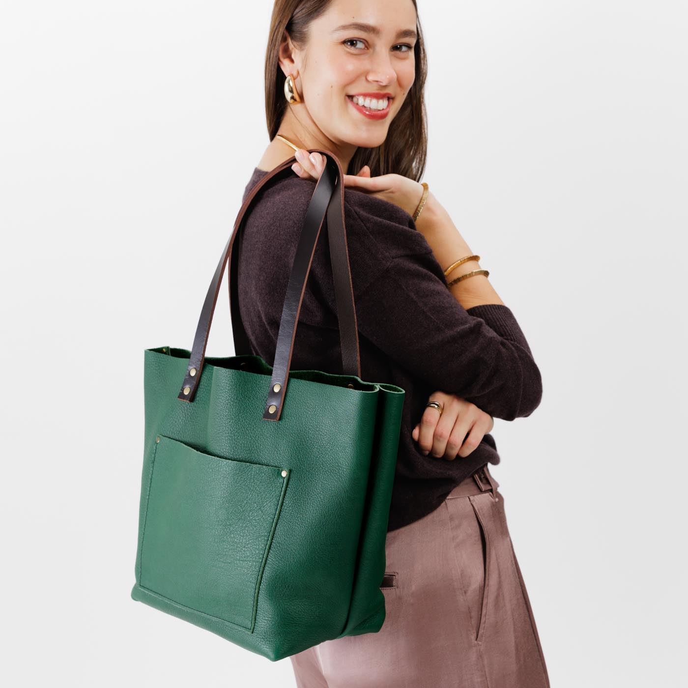 Bacalar Classic | Model holding large leather tote bag with sturdy bridle handles and front pocket