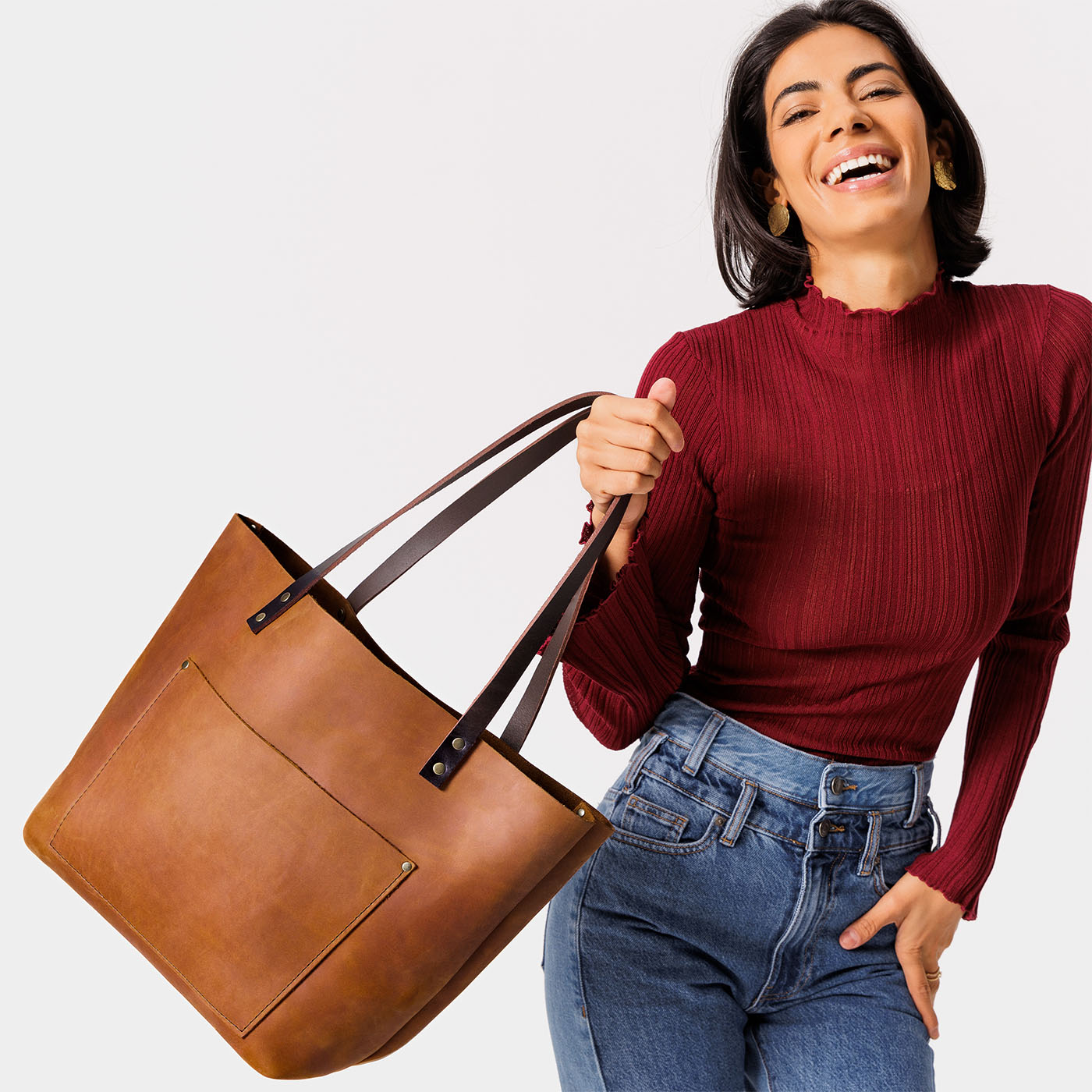 Dakota*Classic | Model holding large leather tote bag with sturdy bridle handles and front pocket