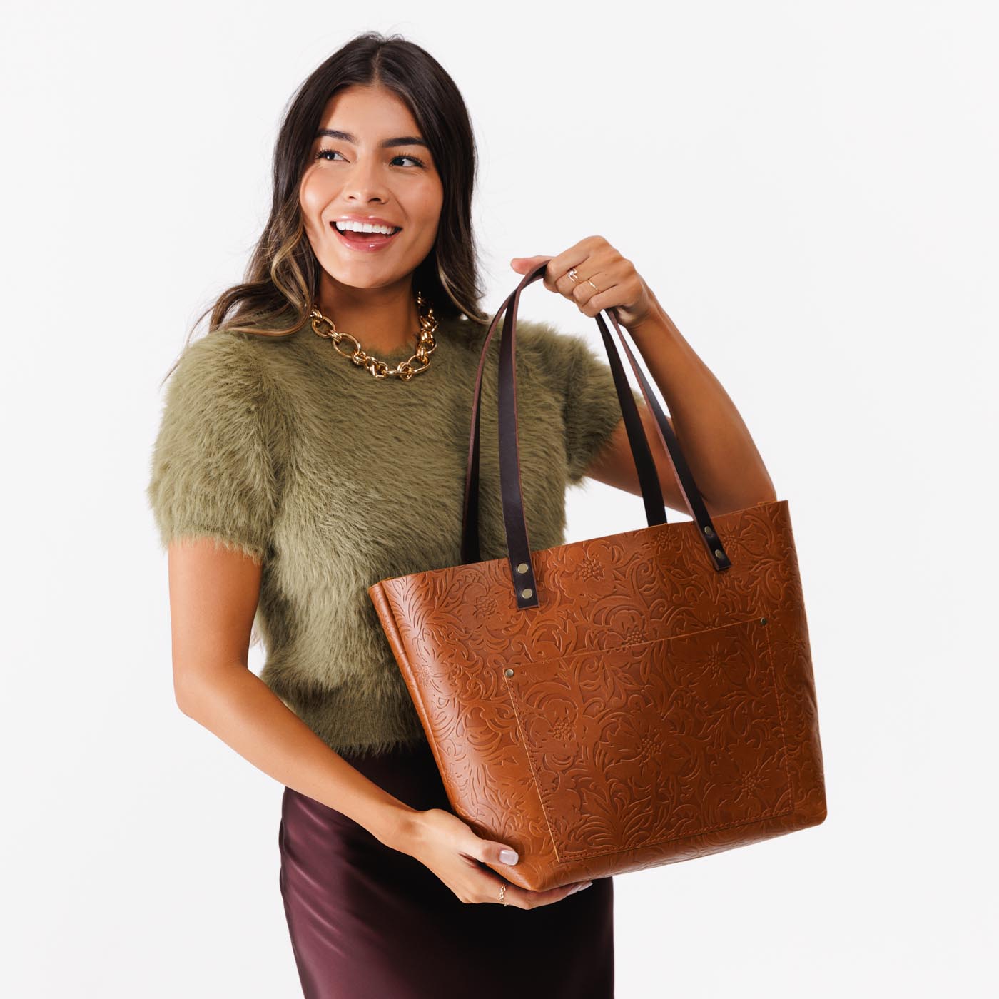 Meadow*Classic | Model holding large zipper leather tote bag with sturdy bridle handles and front pocket