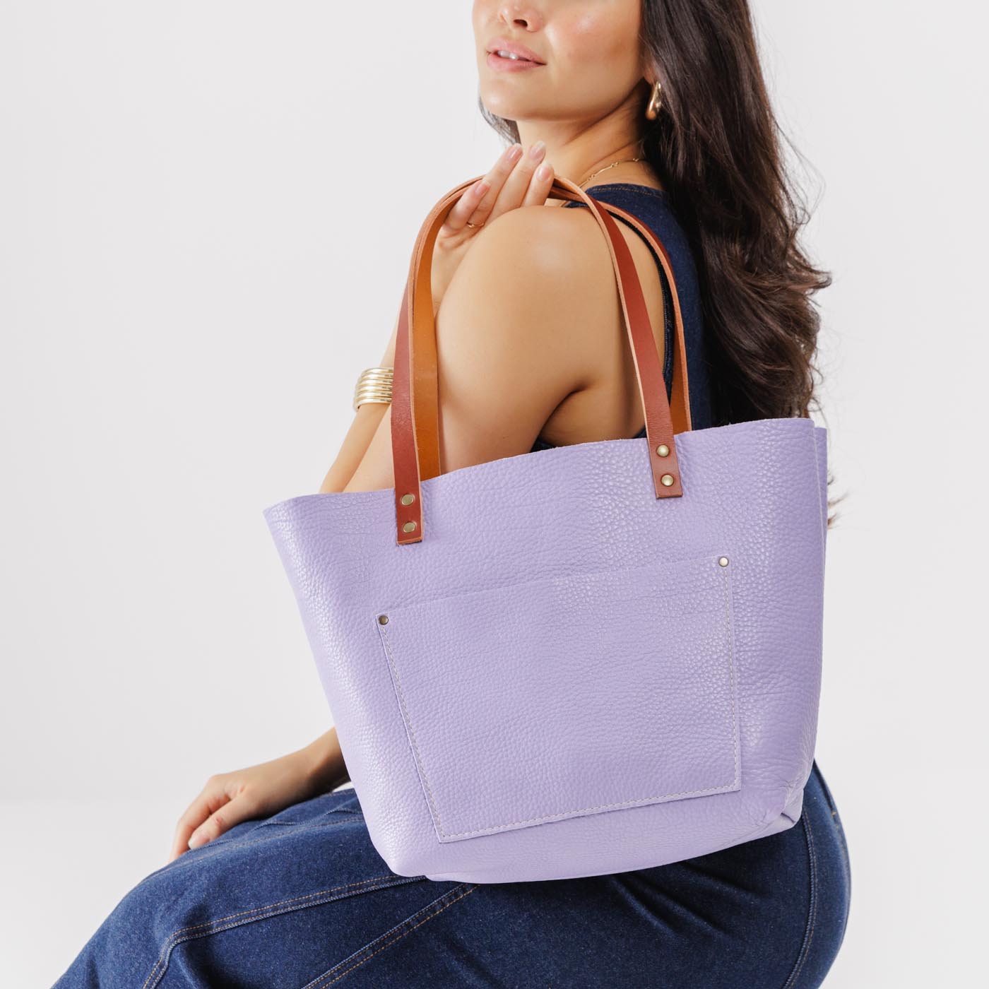 Wisteria*Classic | Model holding large leather tote bag with sturdy bridle handles and front pocket