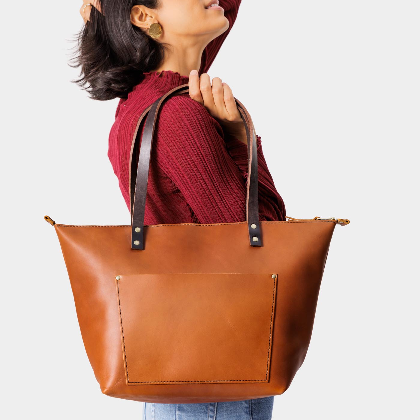 Honey*Zipper | Model holding large zipper leather tote bag with sturdy bridle handles and front pocket