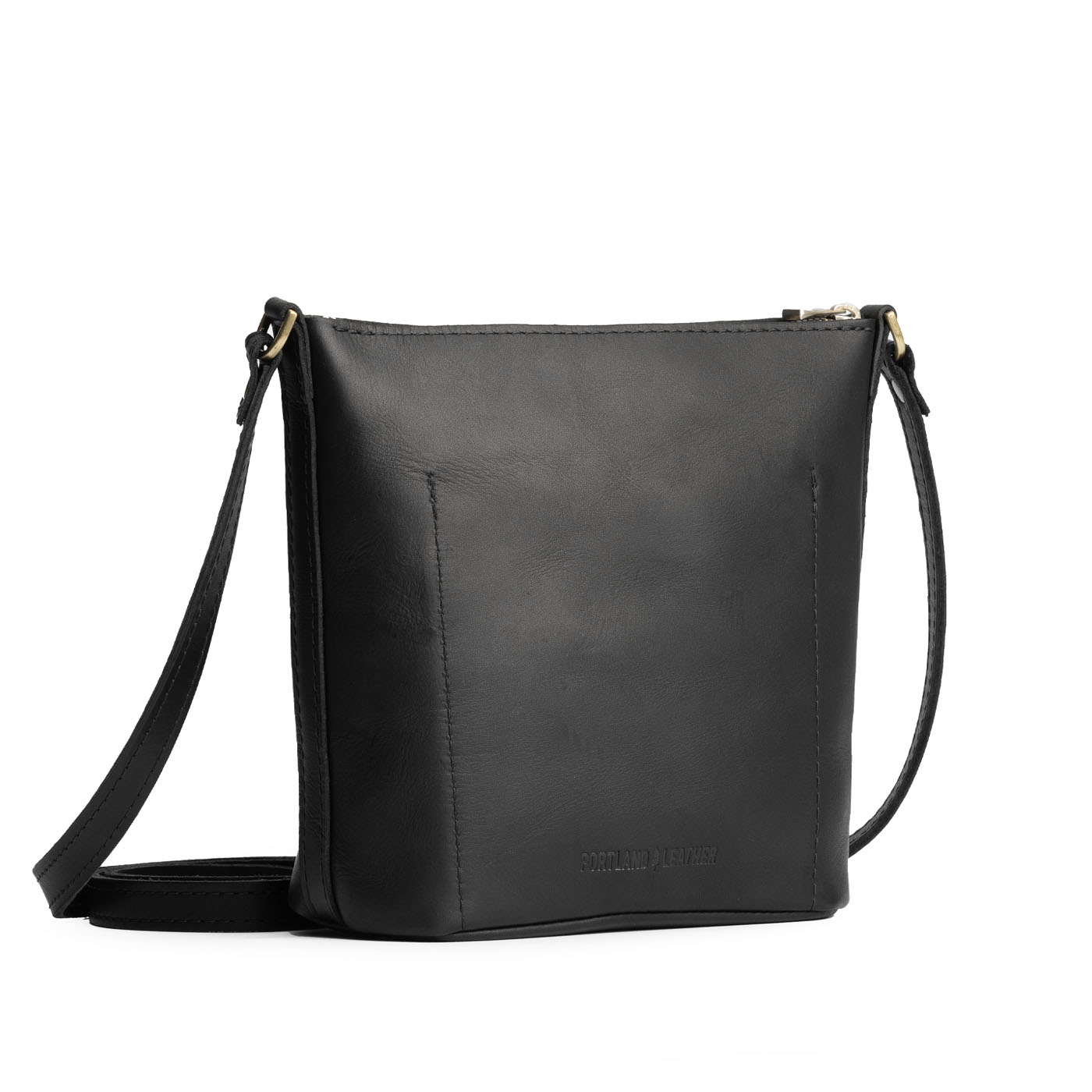 Black | Back of rectangular side bag with curved front pocket and metal tree shaped badge