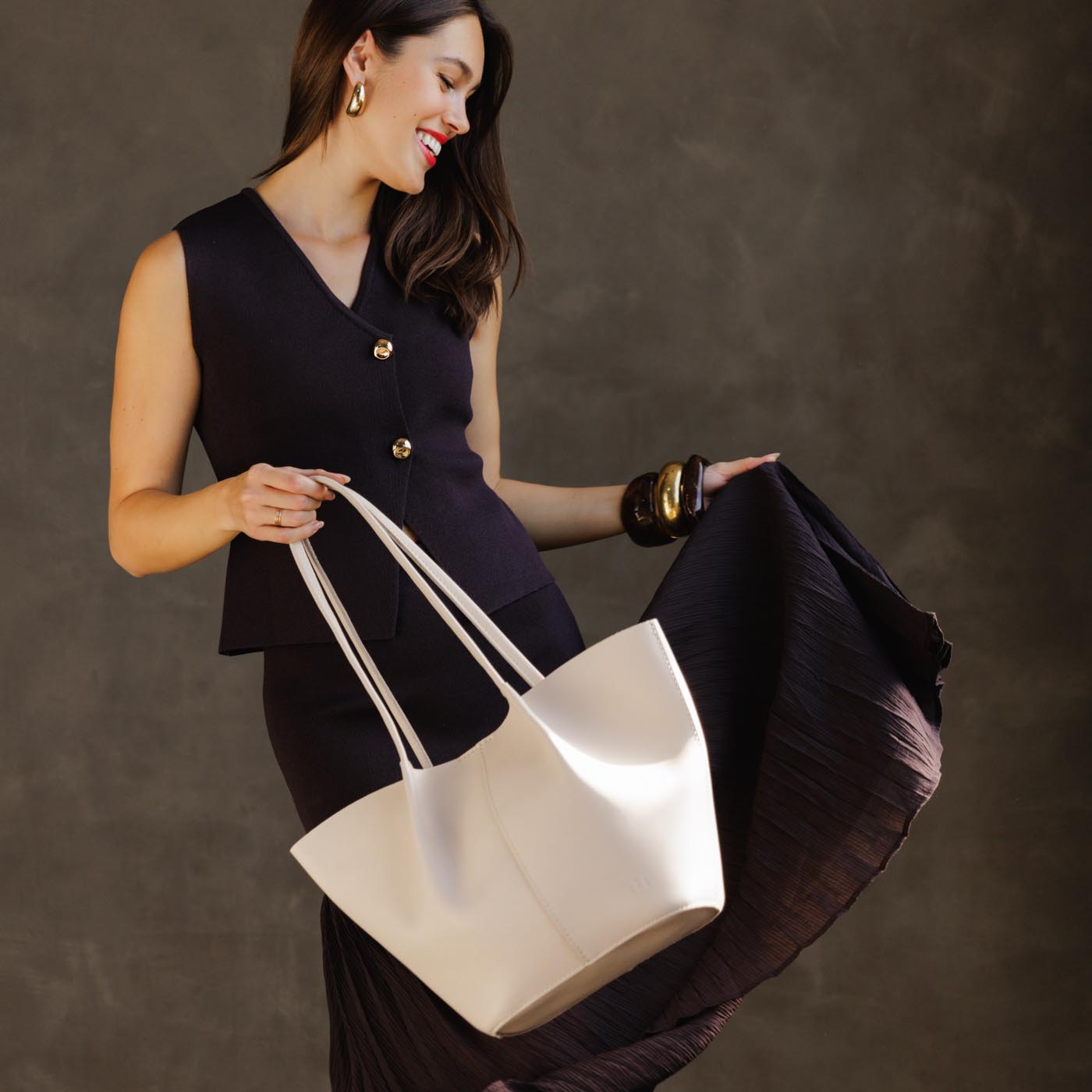 Bone*Large | Model holding wide bucket shaped tote bag with matching leather handles