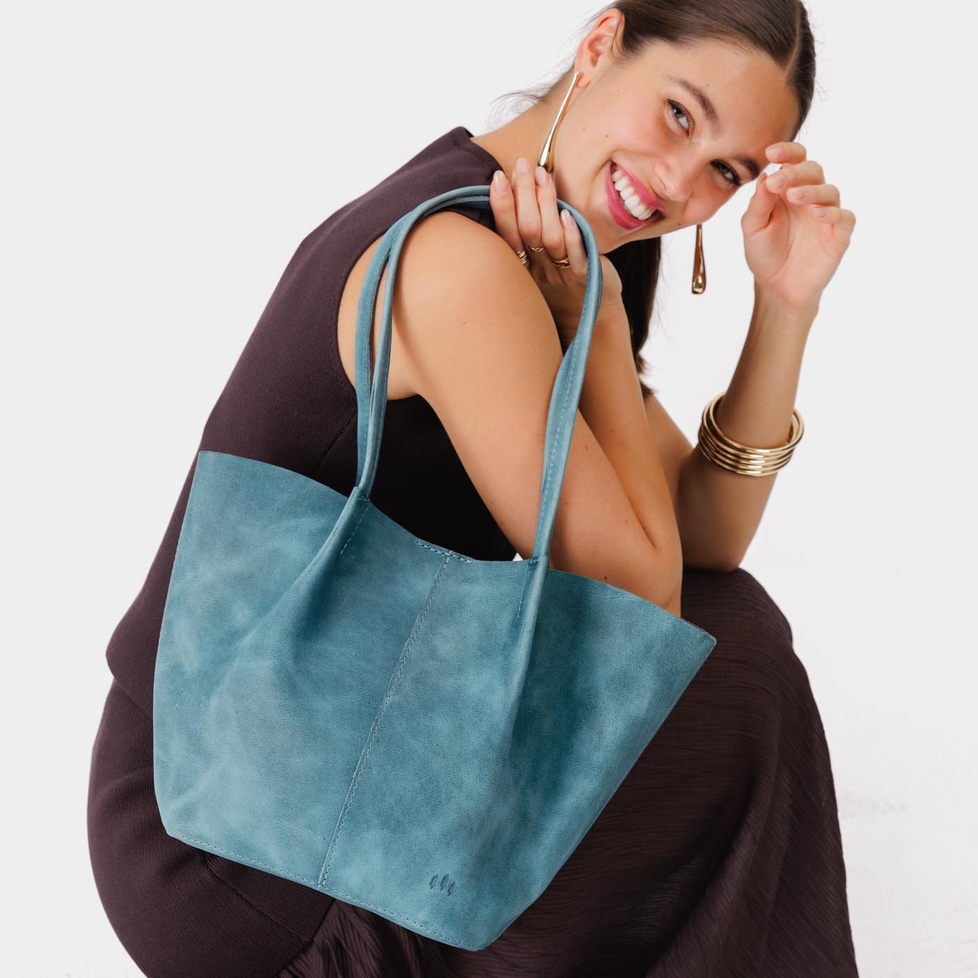 Aqua*Large | Model holding wide bucket shaped tote bag with matching leather handles