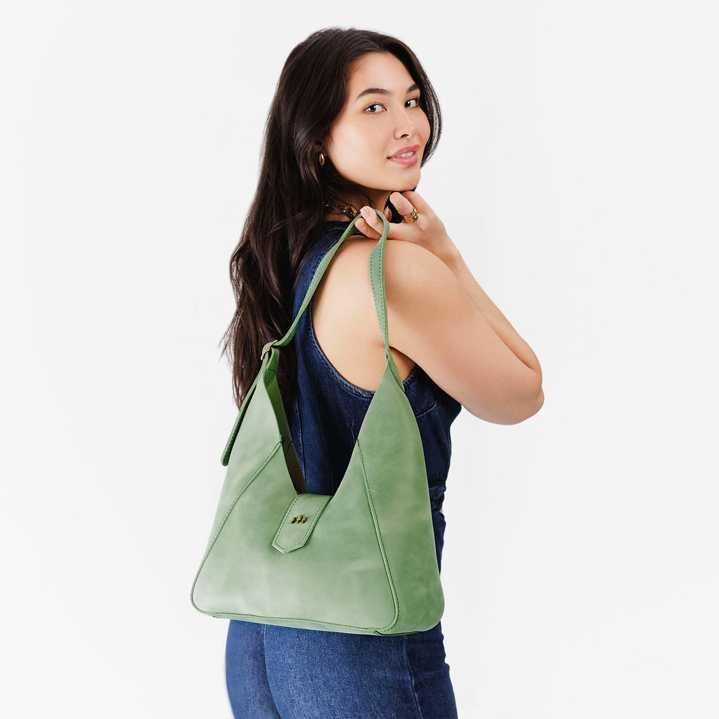 Cucumber | Model wearing structured hobo shoulder bag with adjustable strap and magnetic closure