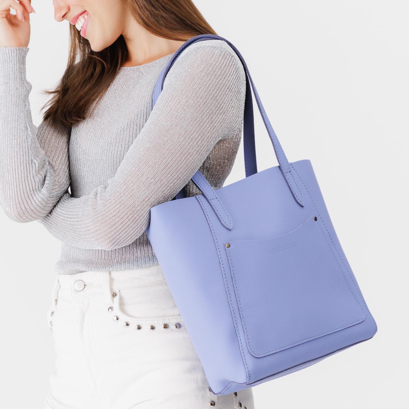 Jacaranda*Large | Model holding dual shoulder strap tote bag with an exterior pocket