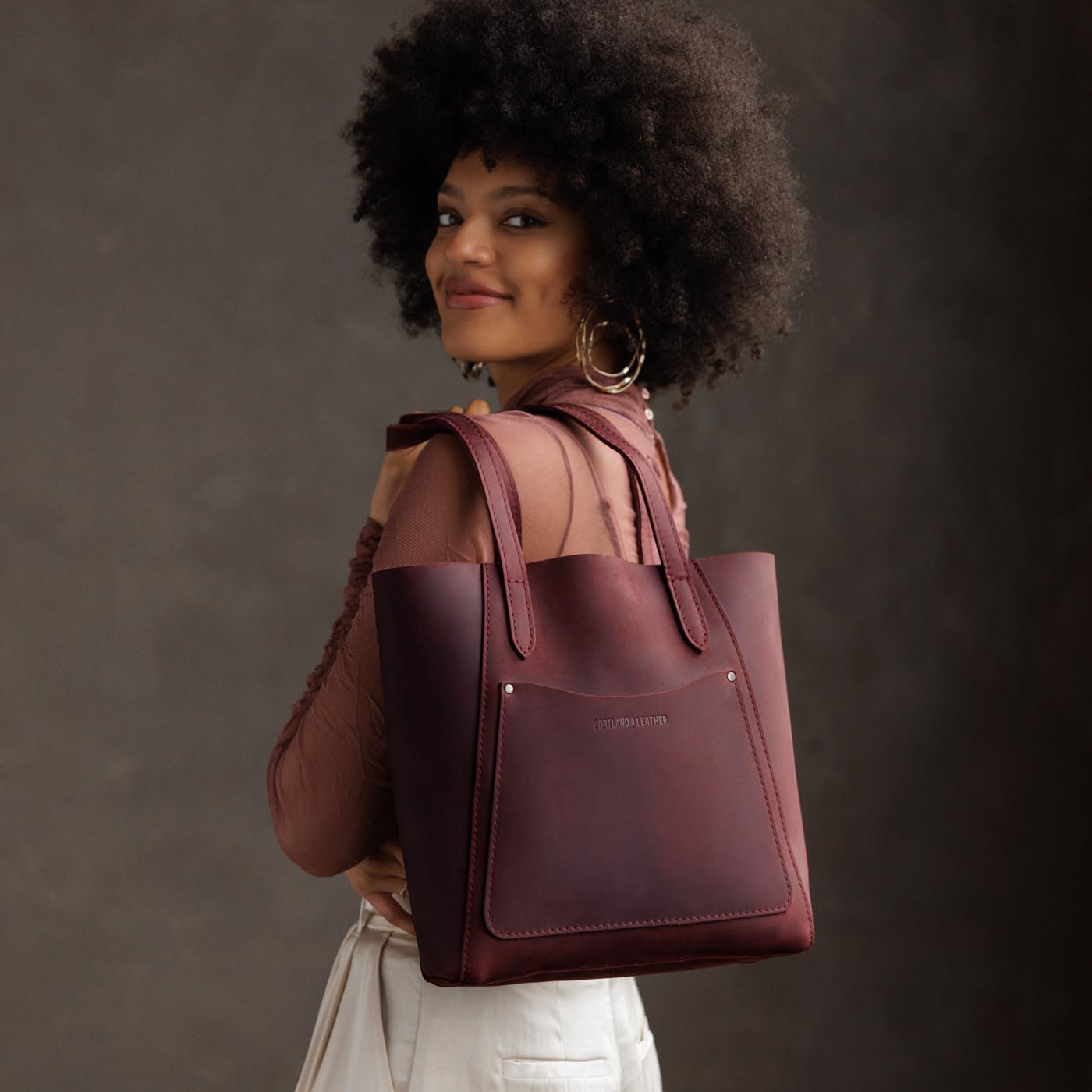 Merlot*Large | Model holding dual shoulder strap tote bag with an exterior pocket