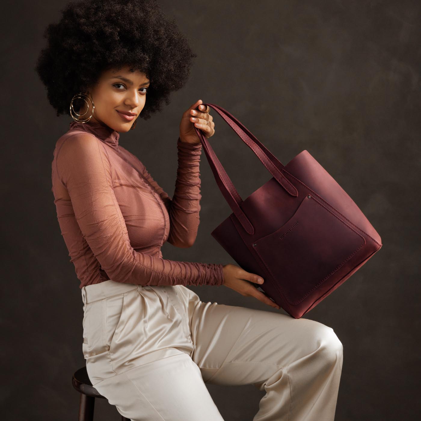 Merlot*Large | Model holding dual shoulder strap tote bag with an exterior pocket