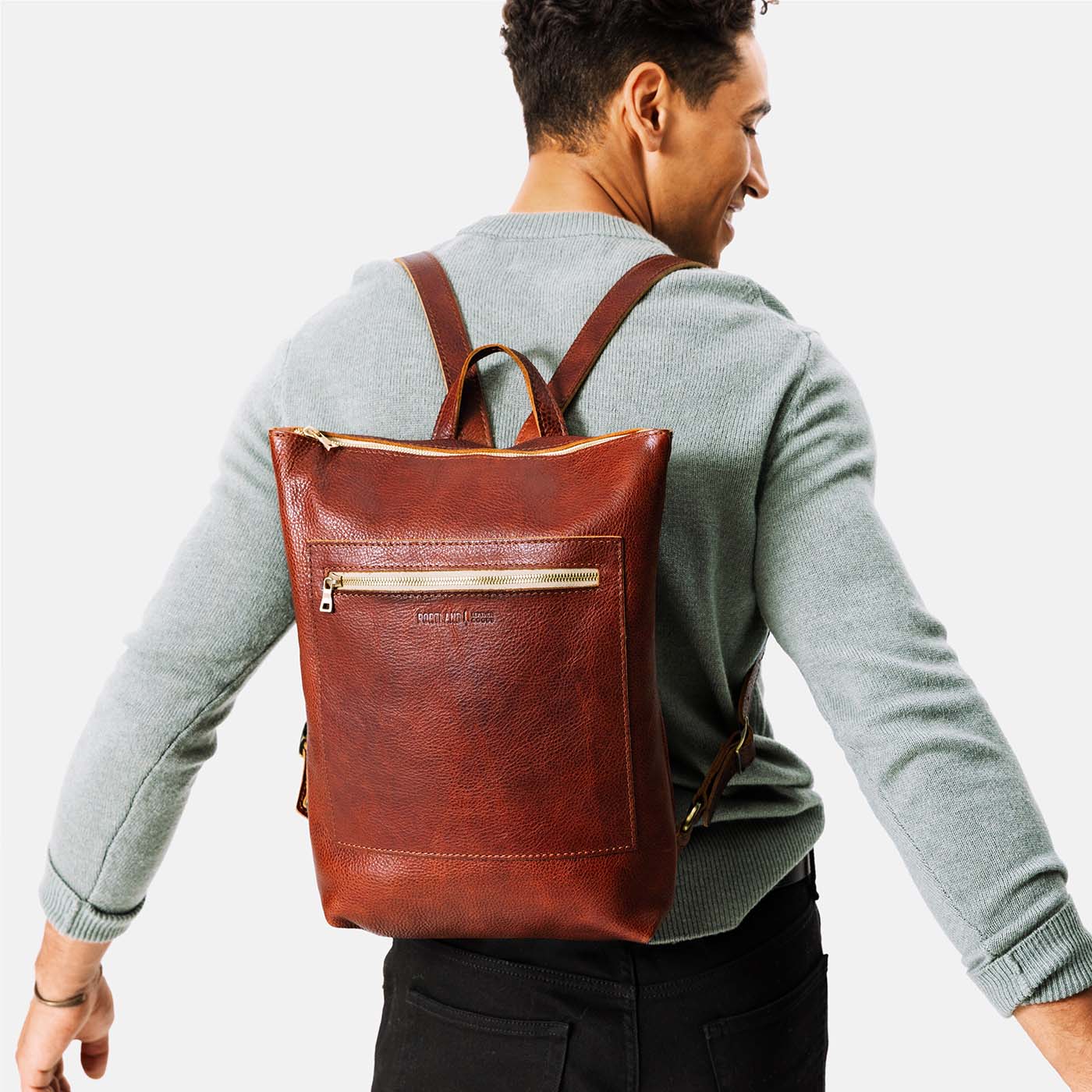 All Color: Nutmeg | Model wearing rectangular slim leather laptop backpack