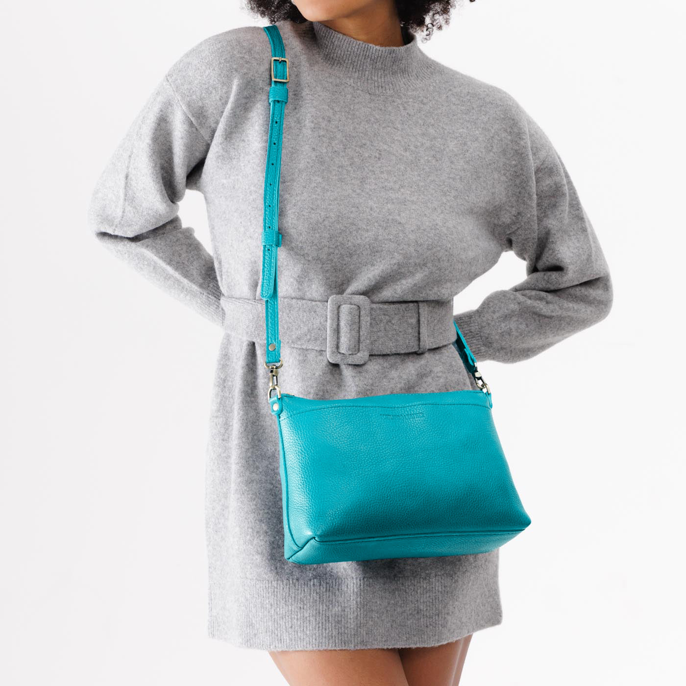 Baja | Model holding midsize zip top crossbody bag with detachable strap