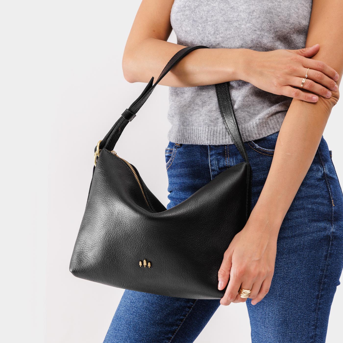 Pebbled--black Large | Medium sized slouchy leather shoulder bag with zipper opening and three metal tree emblems