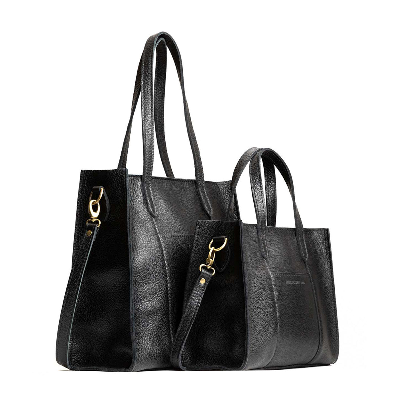 Pebbled--black | Structured mid-size tote bag with overlapping panels and crossbody strap