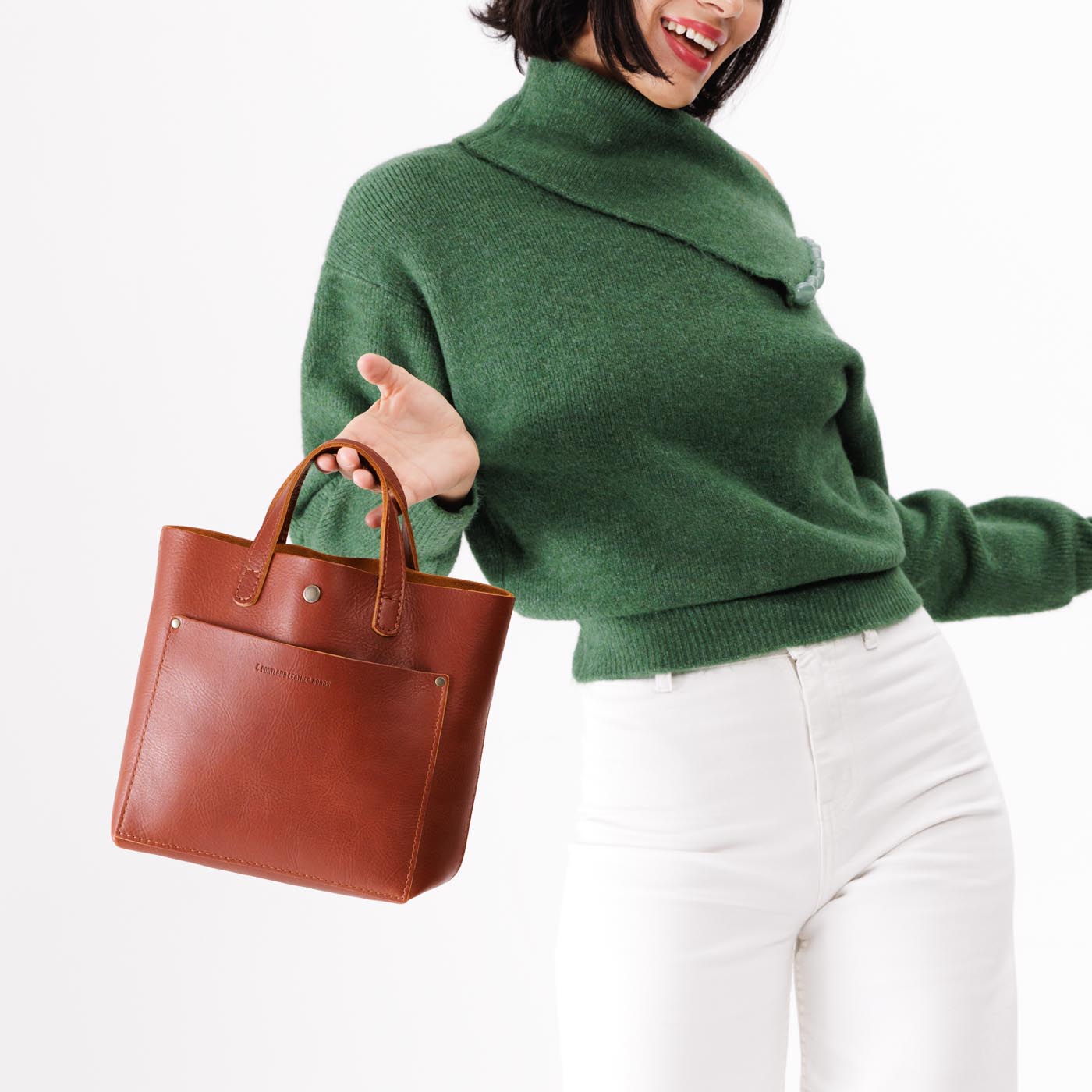 Chestnut*Classic | Model holding crossbody tote bag with snap closure and front pocket