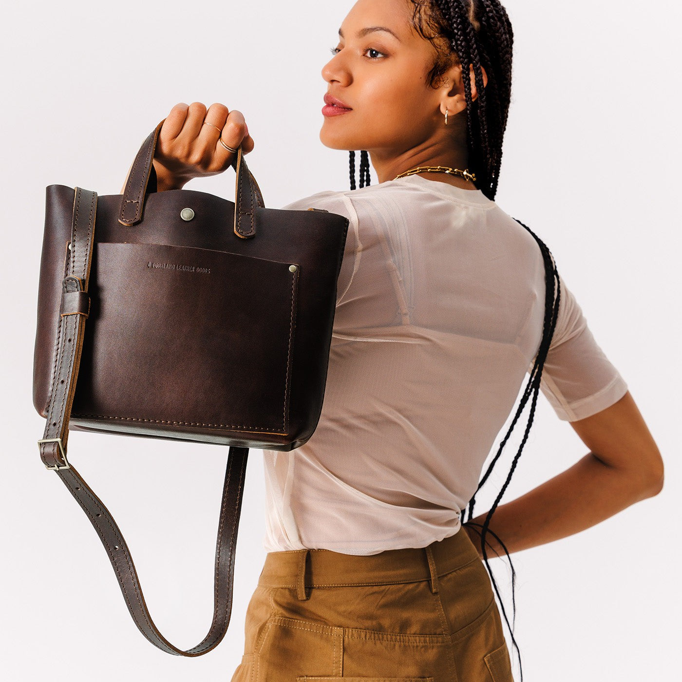 Grizzly*Classic | Model holding crossbody tote bag with snap closure and front pocket