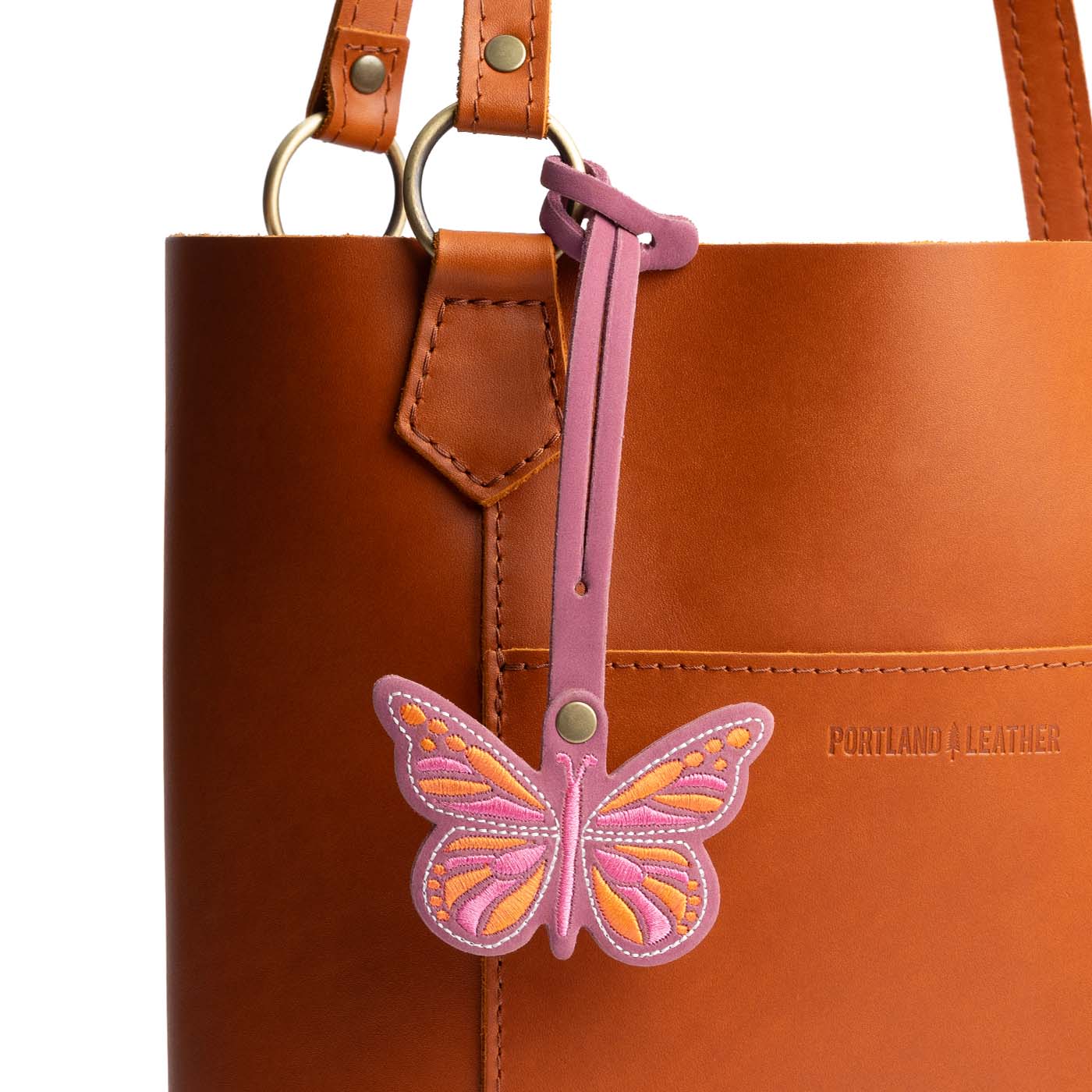 Foxglove | Embroidered butterfly tassel accessory on a bag