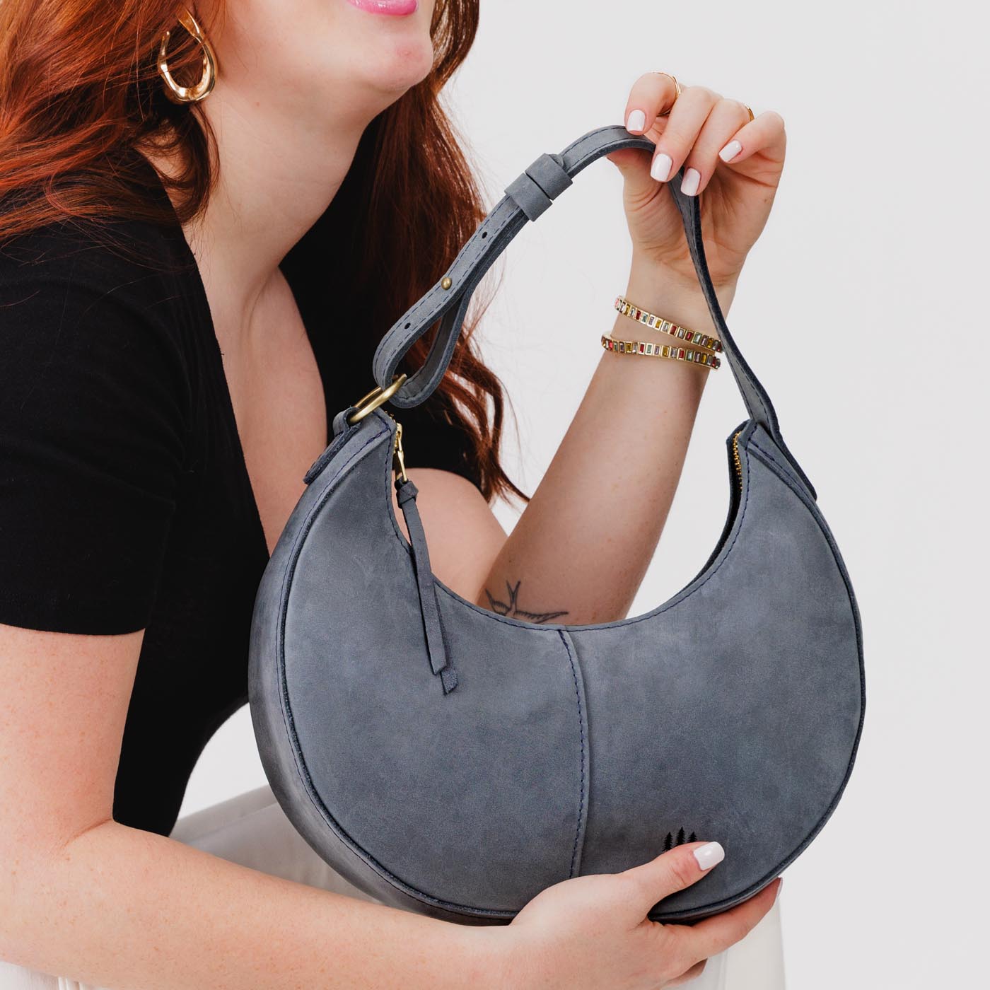 Storm*Classic | Crescent shaped shoulder bag with zipper closure and adjustable strap