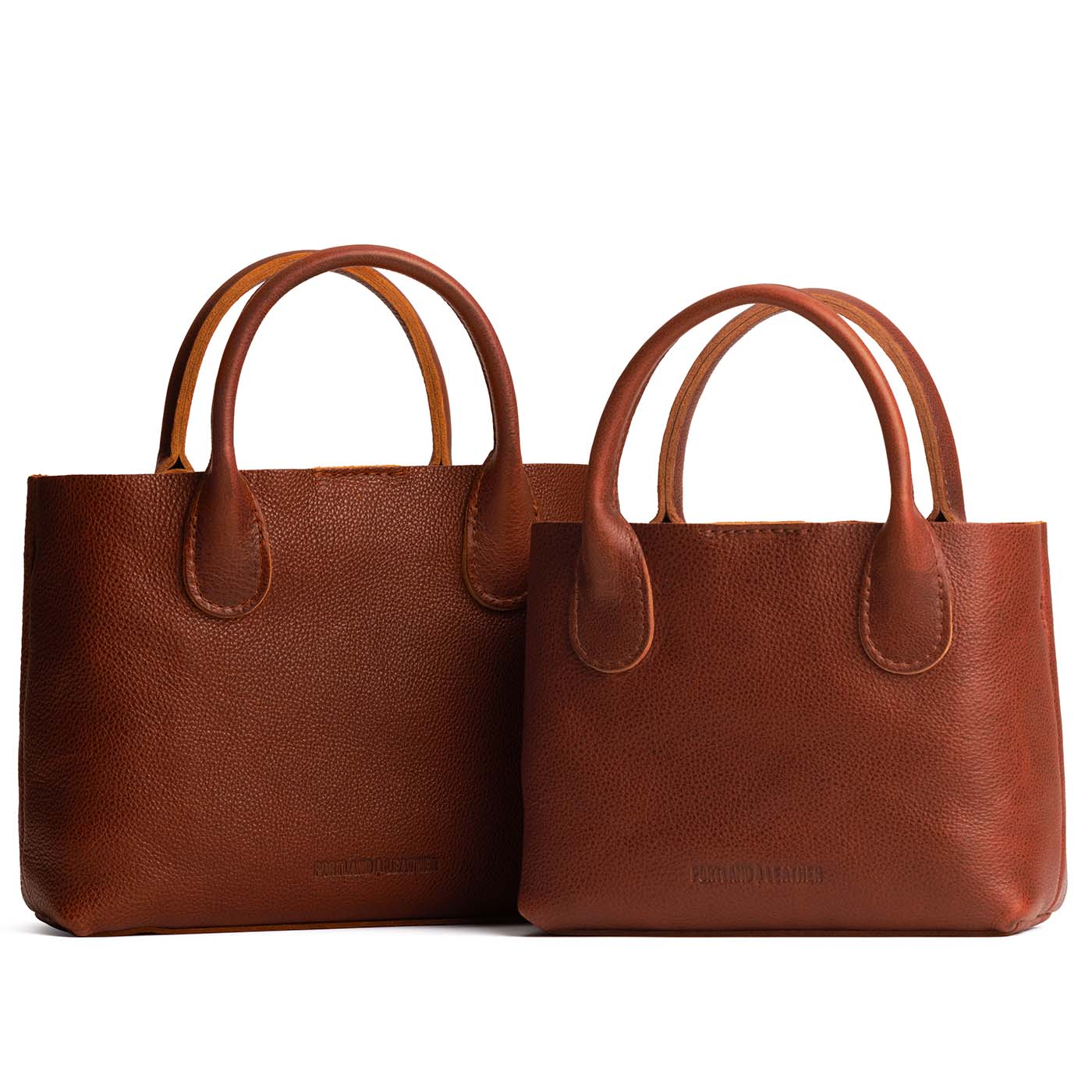 Nutmeg | Side by side of both tote purses with structured leather handles and crossbody strap