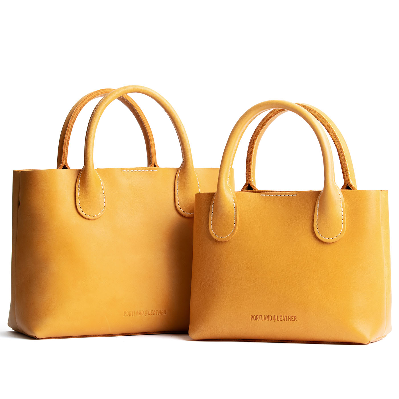 Sunflower | Side by side of both tote purses with structured leather handles and crossbody strap