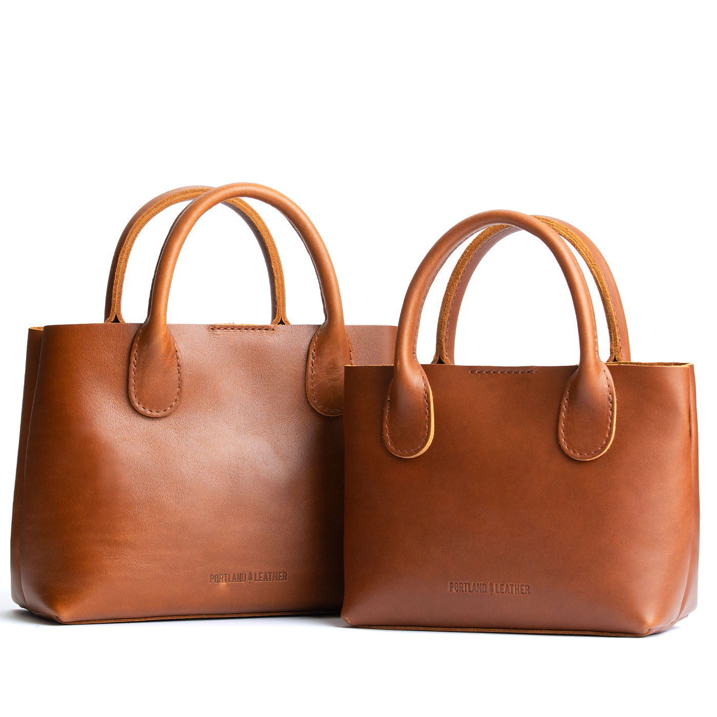 Honey | Side by side of both tote purses with structured leather handles and crossbody strap