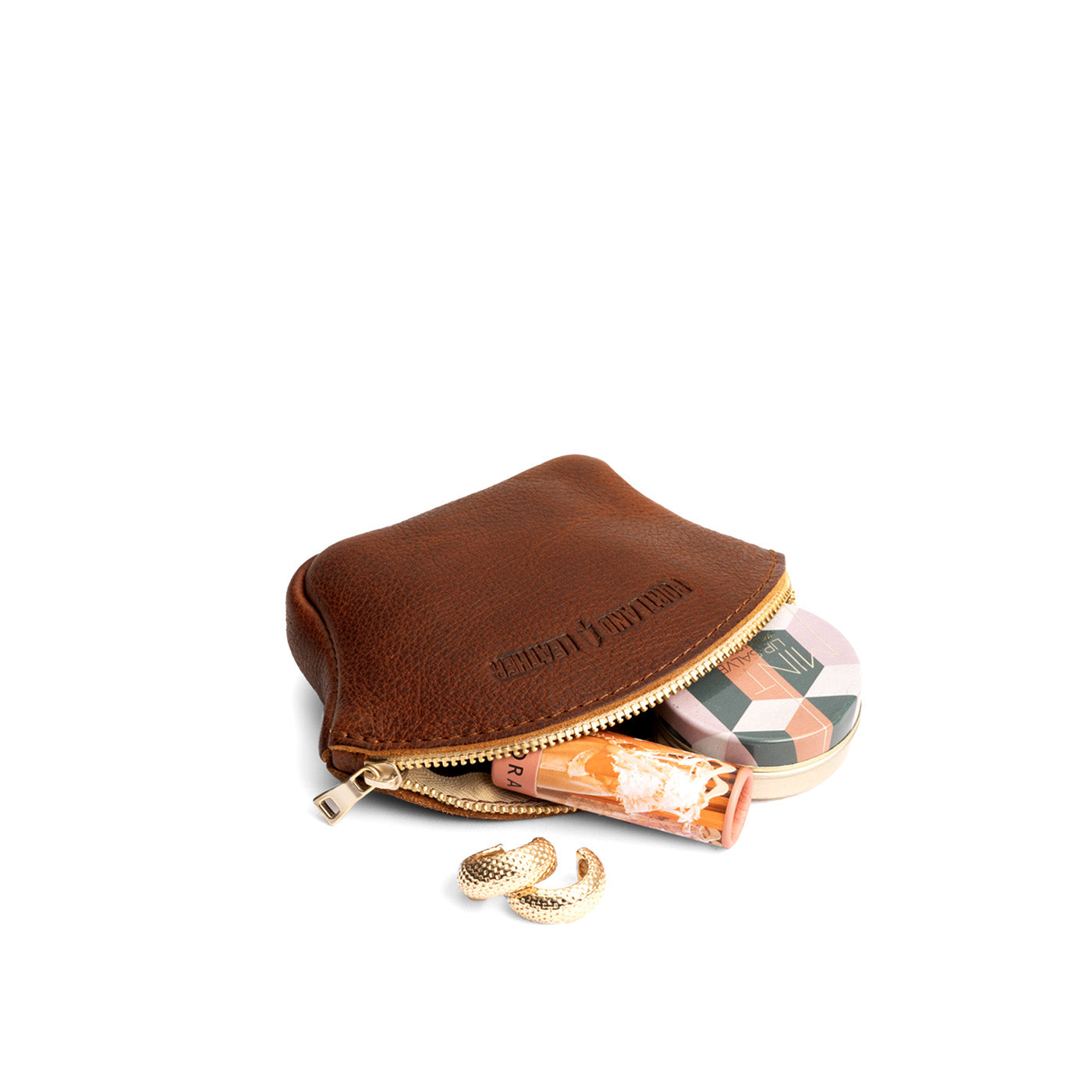 Nutmeg Small | Seashell shaped leather makeup bag with curved top zipper open and flat bottom