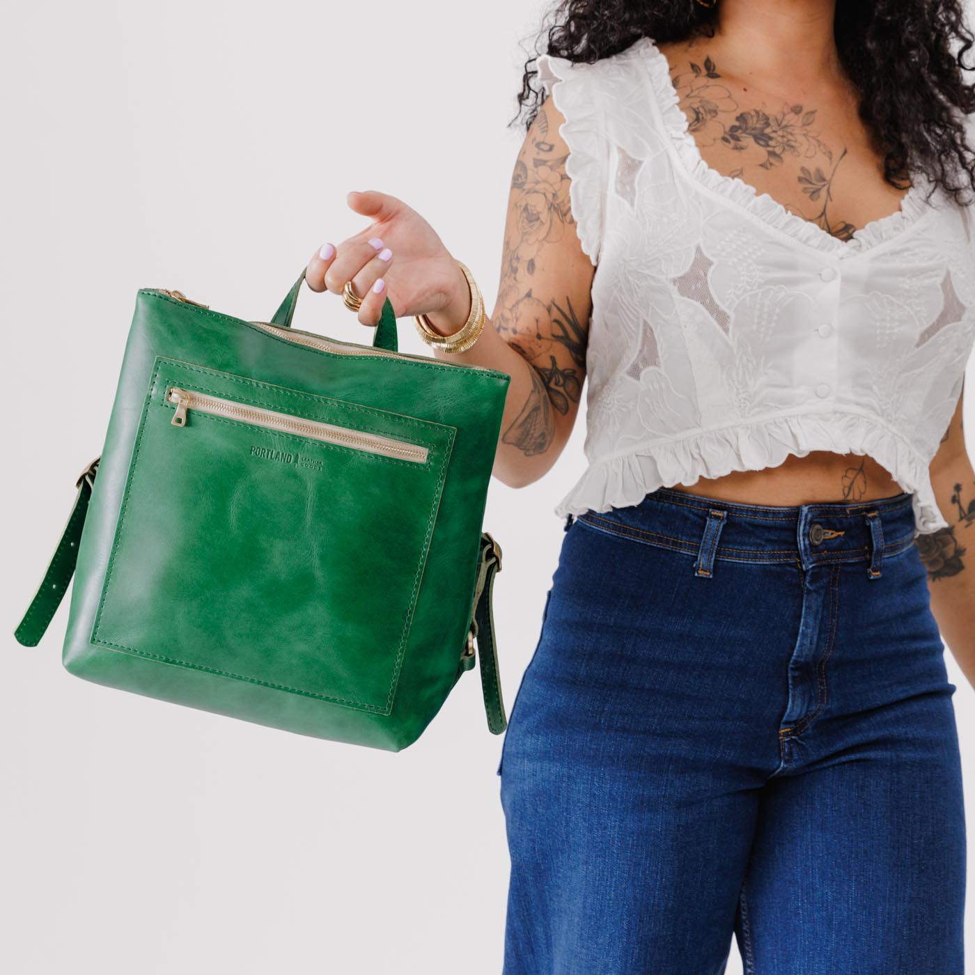 All Color: Cowboy Mint | Model holding square slim leather tote backpack