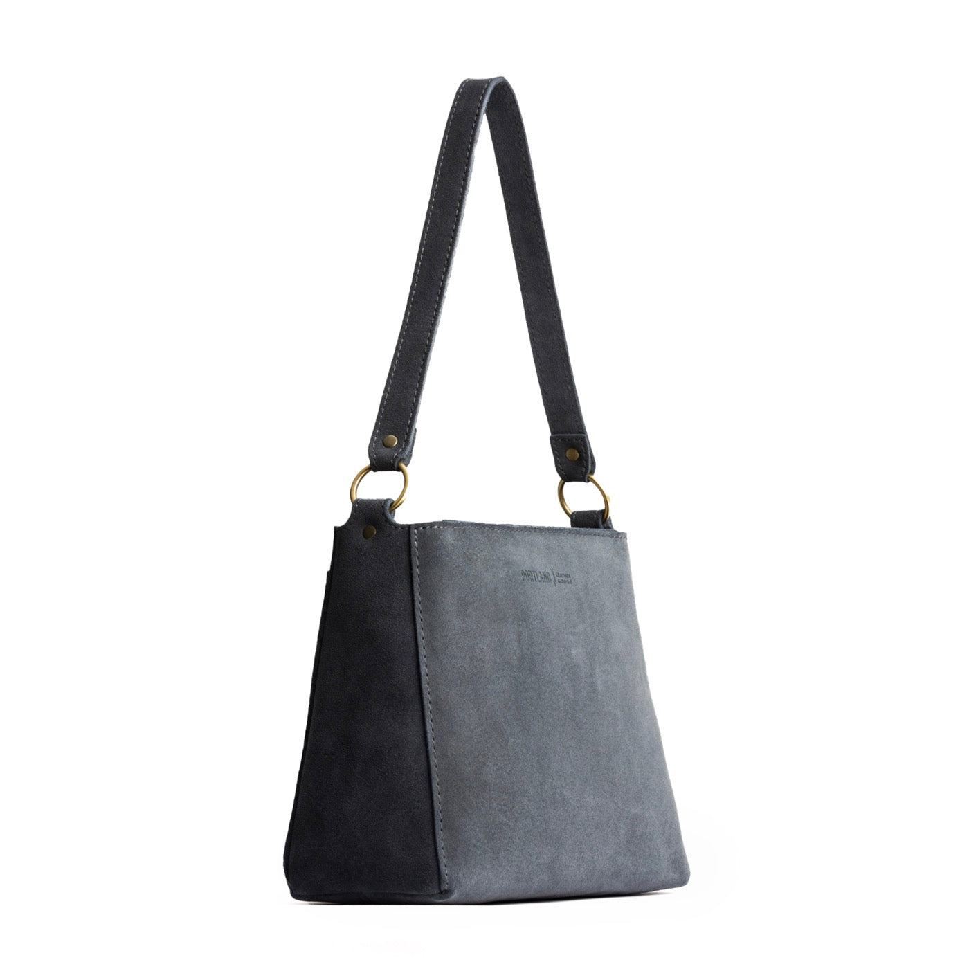 Peppercorn | Triangular shoulder bag with antiqued brass finished hardware