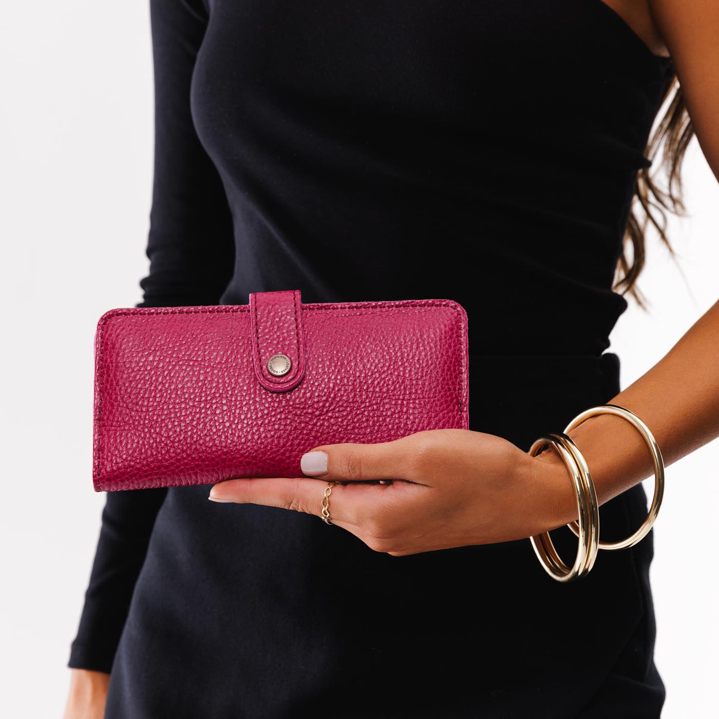 Cosmo | Model holding leather wallet with snap closed