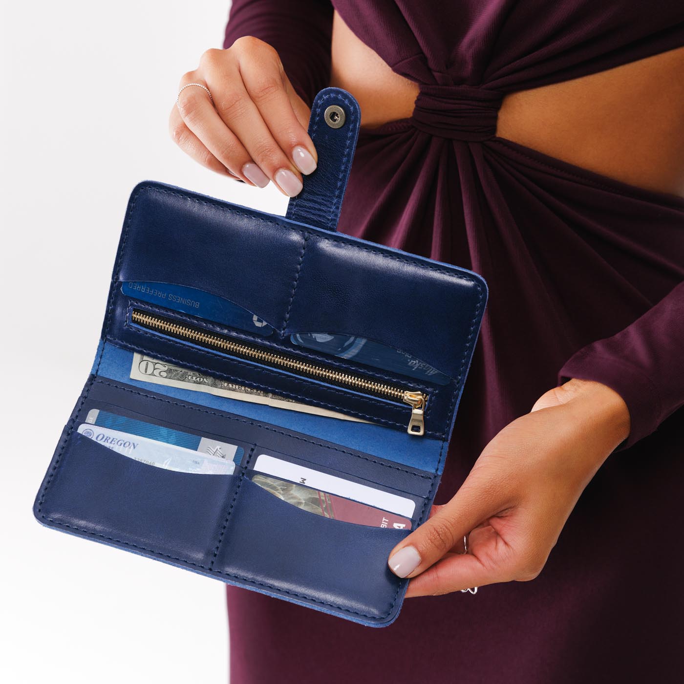 Cowboy Blue | Model holding leather wallet with snap open