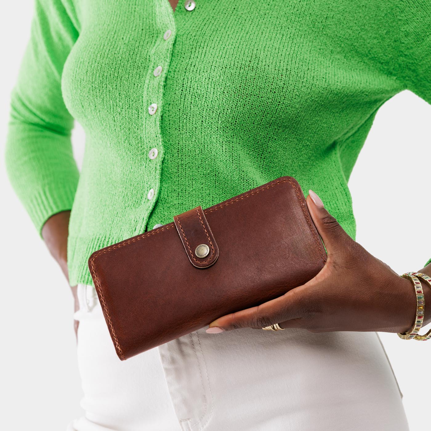 English Tan | Model holding leather wallet with snap closed