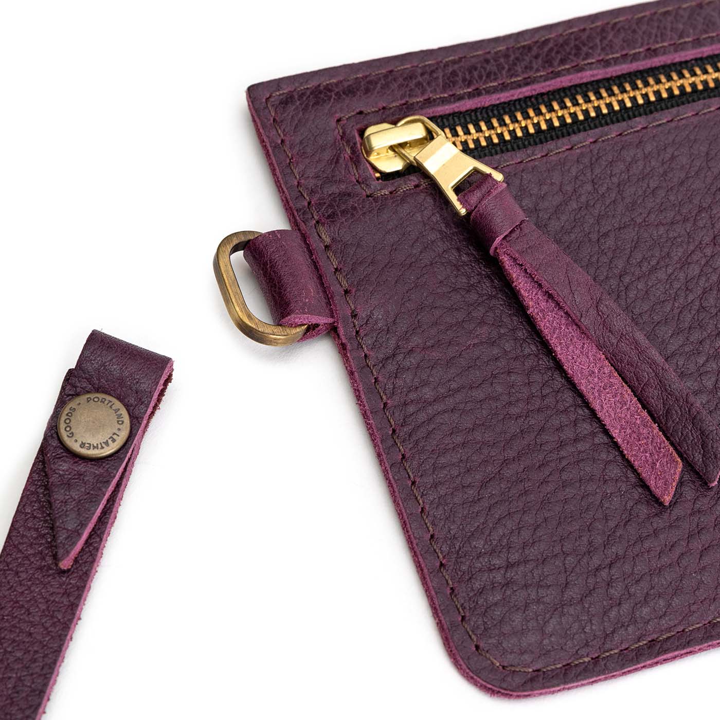 Plum | Flat leather pouch with zipper and wristlet close up