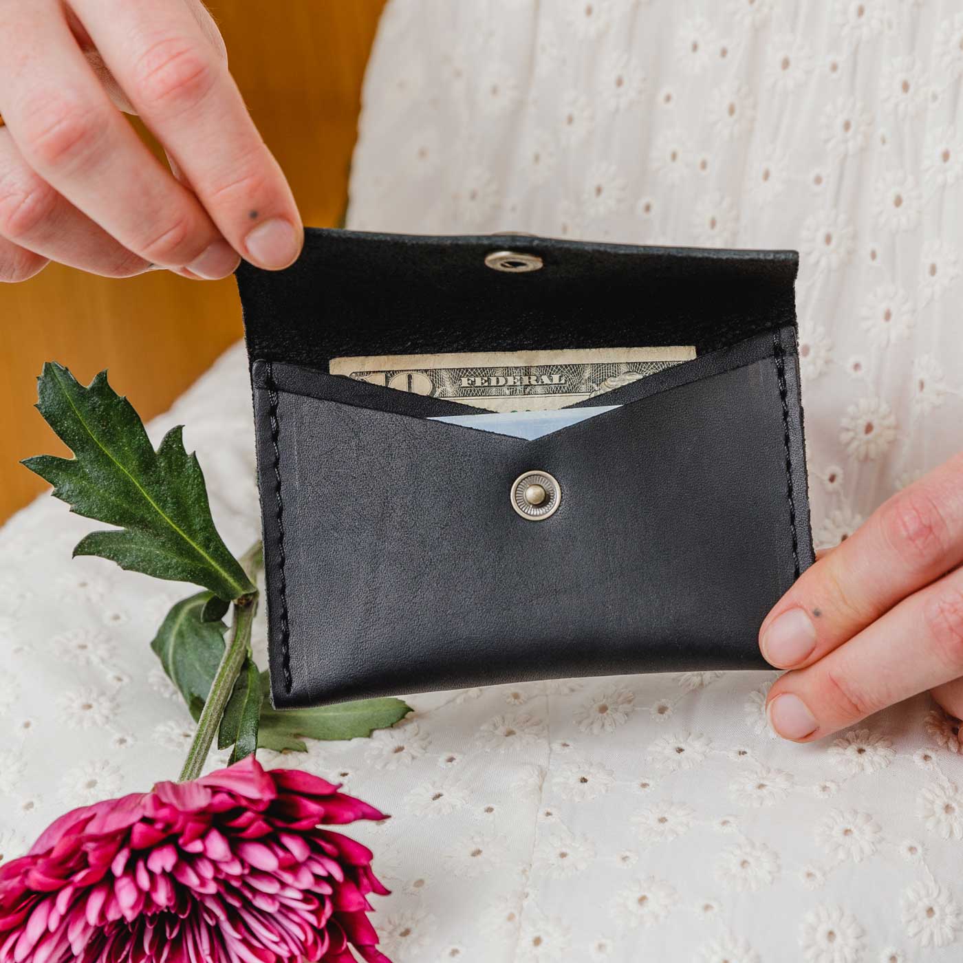 Black | Model holding small leather envelope card wallet open