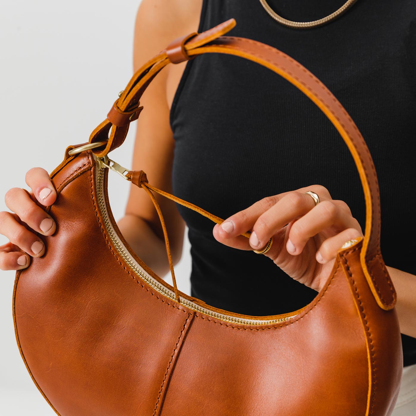 Honey*Classic | Crescent shaped shoulder bag with zipper closure and adjustable strap