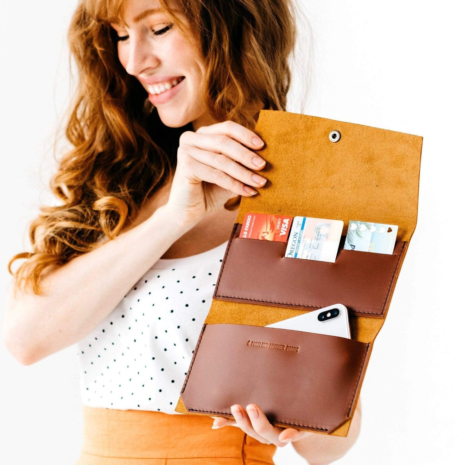 Honey | Model holding leather wallet with snap closure open