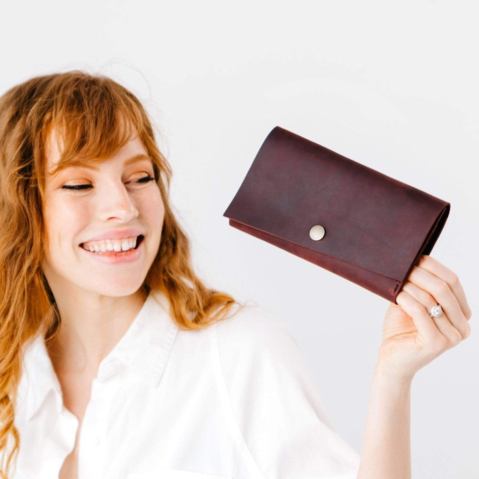 Merlot | Model holding leather wallet with snap closure