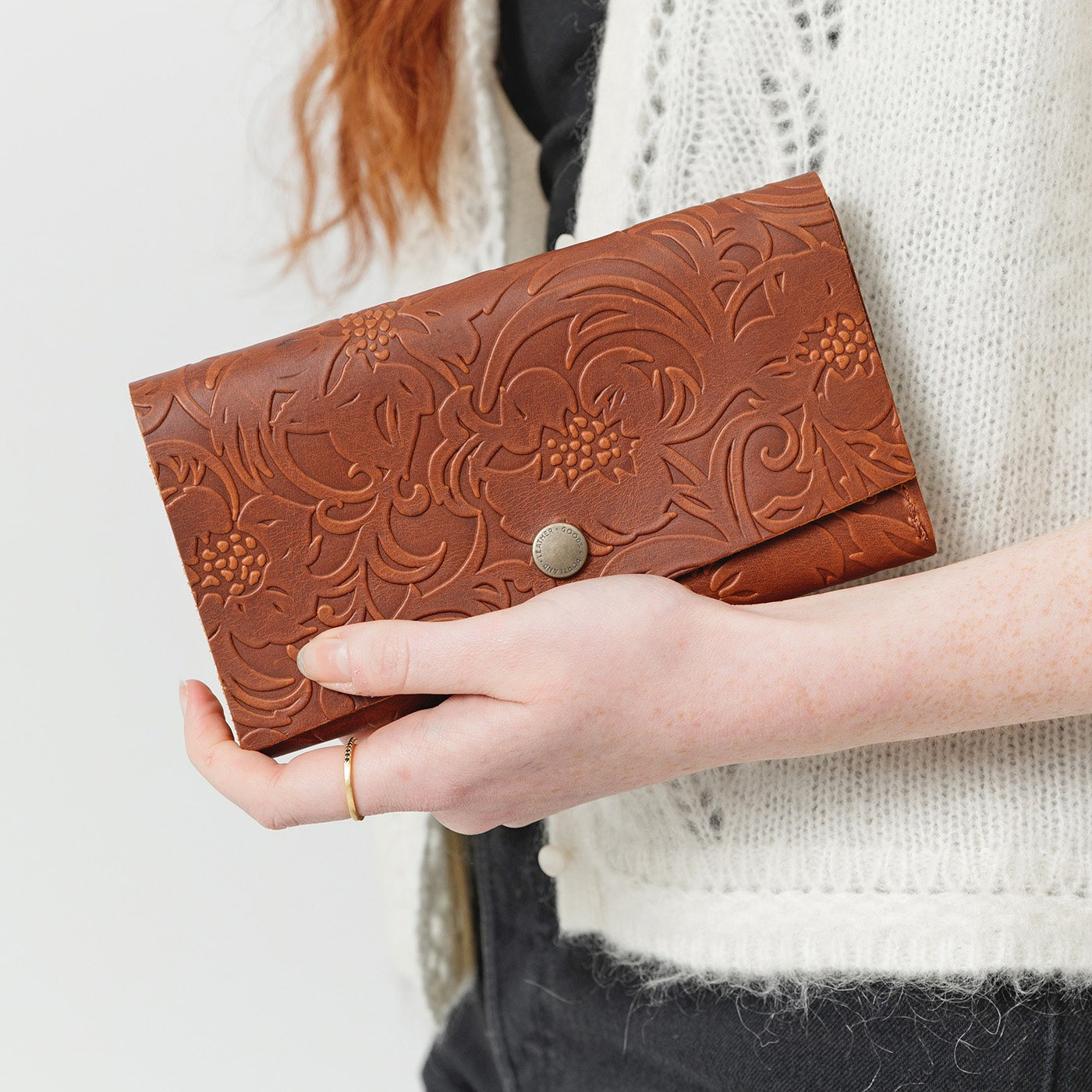 Meadow | Model holding leather wallet with snap closure