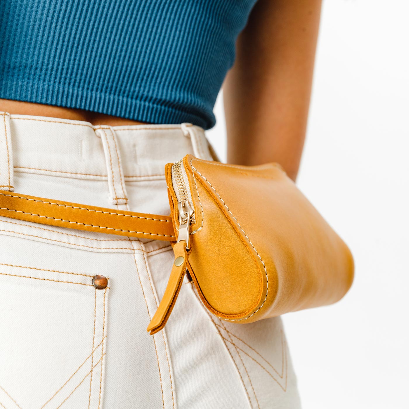  Sunflower | Close up of model wearing petite bag with top zipper closure and adjustable belt strap on waist